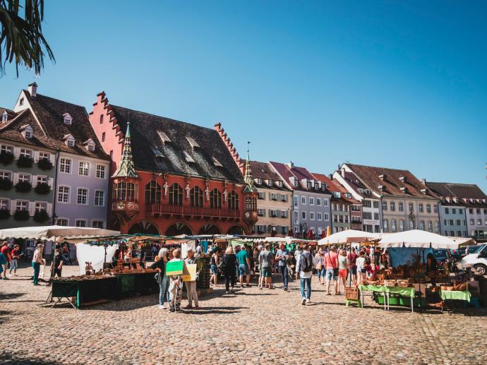 a group of people standing around a market